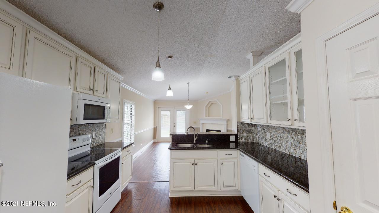 3130 Mountain Ash Road South Jacksonville, FL 32223 - Photo 18 of 60 a kitchen with stainless steel appliances granite countertop a stove a sink and a refrigerator