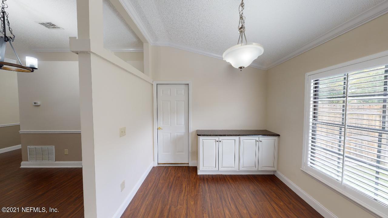 3130 Mountain Ash Road South Jacksonville, FL 32223 - Photo 19 of 60 a view of an empty room with a window and wooden floor