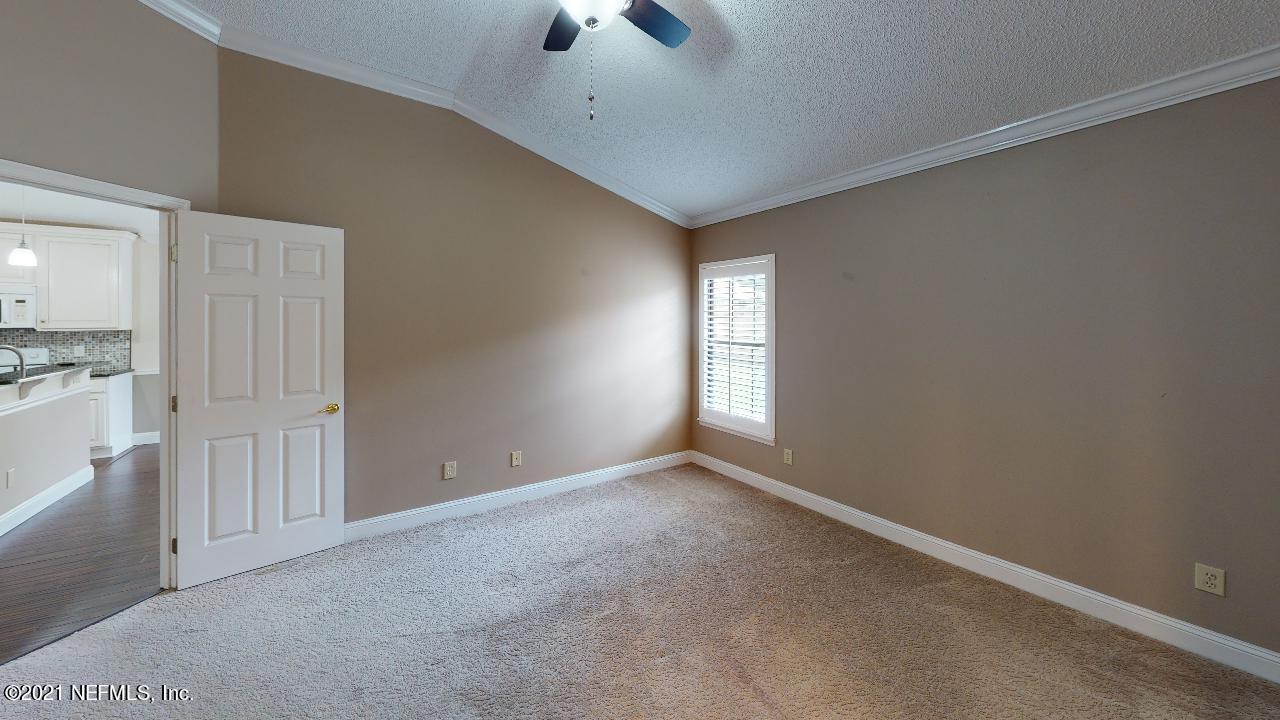3130 Mountain Ash Road South Jacksonville, FL 32223 - Photo 23 of 60 an empty room with chandelier fan and windows