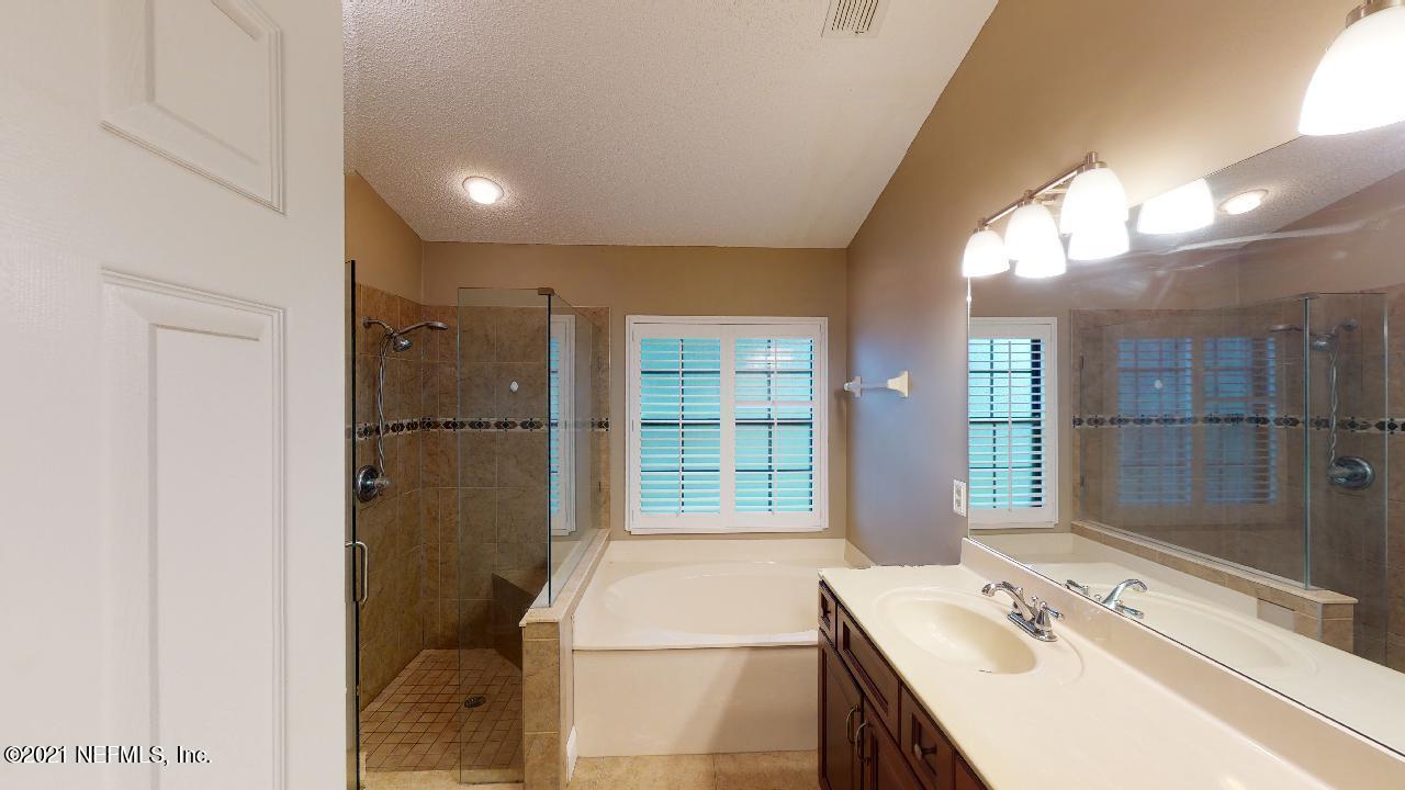 3130 Mountain Ash Road South Jacksonville, FL 32223 - Photo 26 of 60 a bathroom with a tub sink and shower