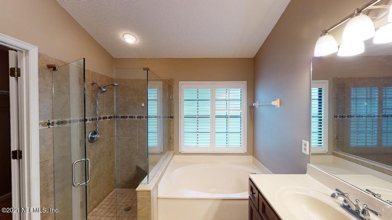 3130 Mountain Ash Road South Jacksonville, FL 32223 - Photo 27 of 60 a bathroom with a tub shower and sink