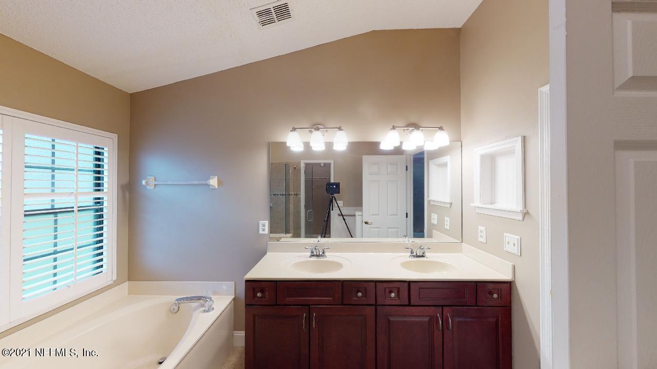 3130 Mountain Ash Road South Jacksonville, FL 32223 - Photo 29 of 60 a bathroom with a sink and a mirror