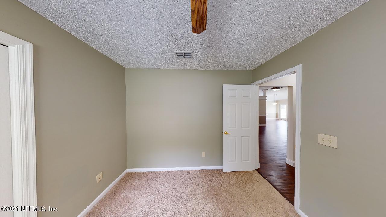 3130 Mountain Ash Road South Jacksonville, FL 32223 - Photo 33 of 60 an empty room with wooden floor and windows