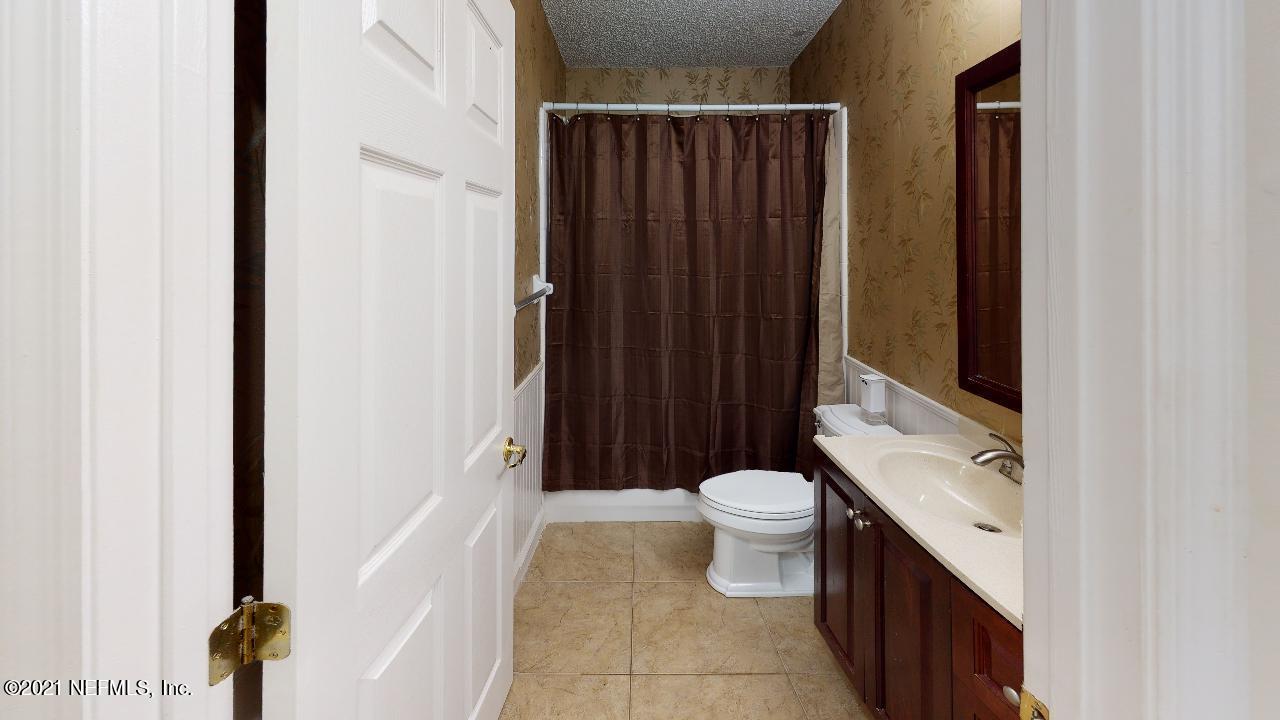 3130 Mountain Ash Road South Jacksonville, FL 32223 - Photo 38 of 60 a bathroom with a sink a toilet a mirror and shower