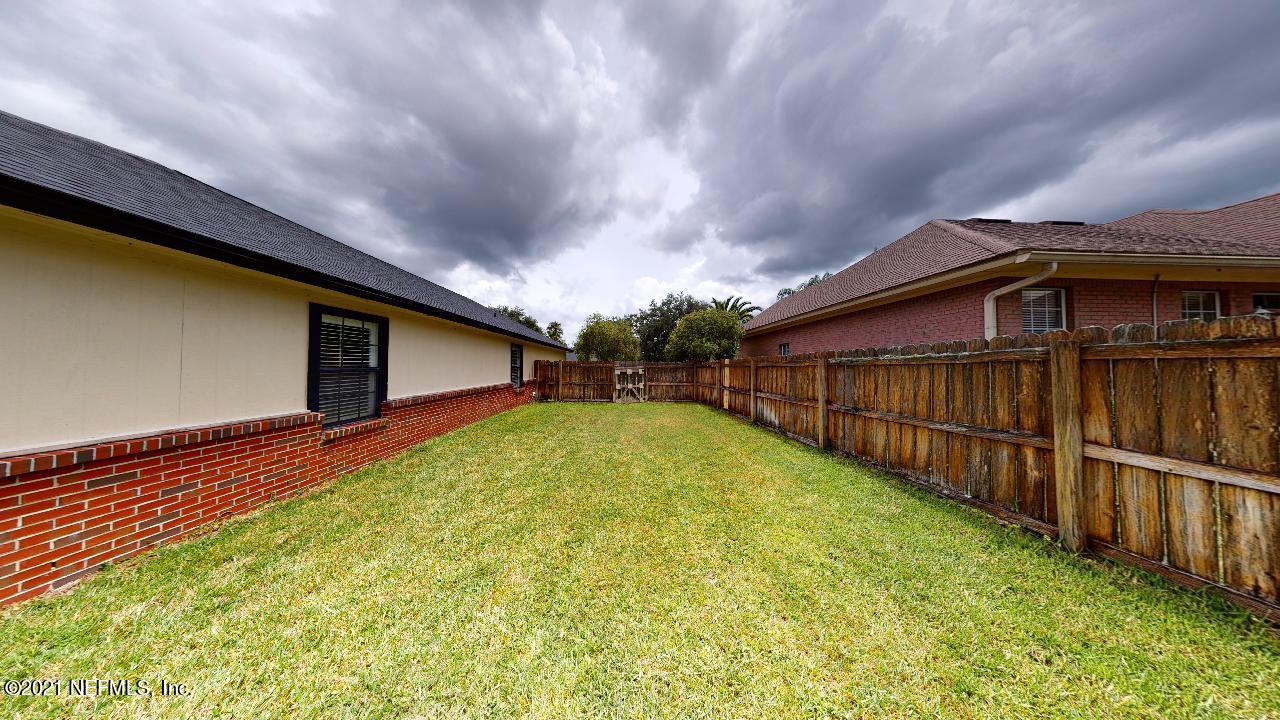 3130 Mountain Ash Road South Jacksonville, FL 32223 - Photo 56 of 60 a view of backyard with small garden and wooden fence