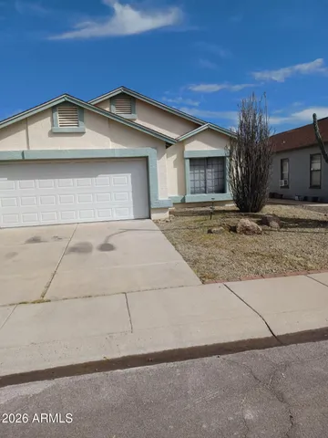 a view of a house with a yard and garage
