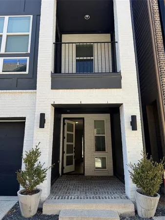 a view of front door and potted plants