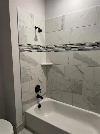 a bathroom with a bathtub and sink