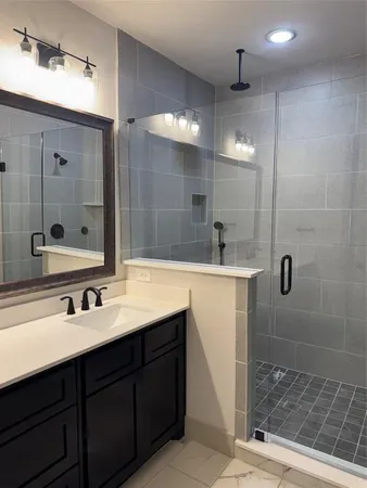 a bathroom with a sink double vanity and a shower