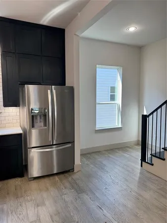 a metallic refrigerator freezer sitting in a kitchen