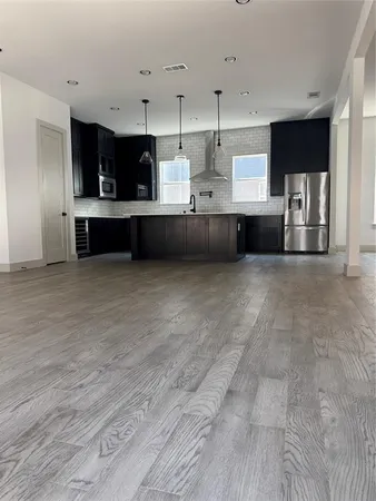 a large kitchen with stainless steel appliances and cabinets