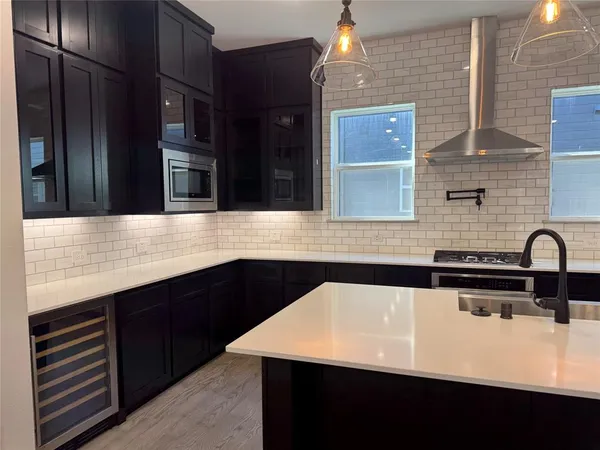 a kitchen with a sink and cabinets
