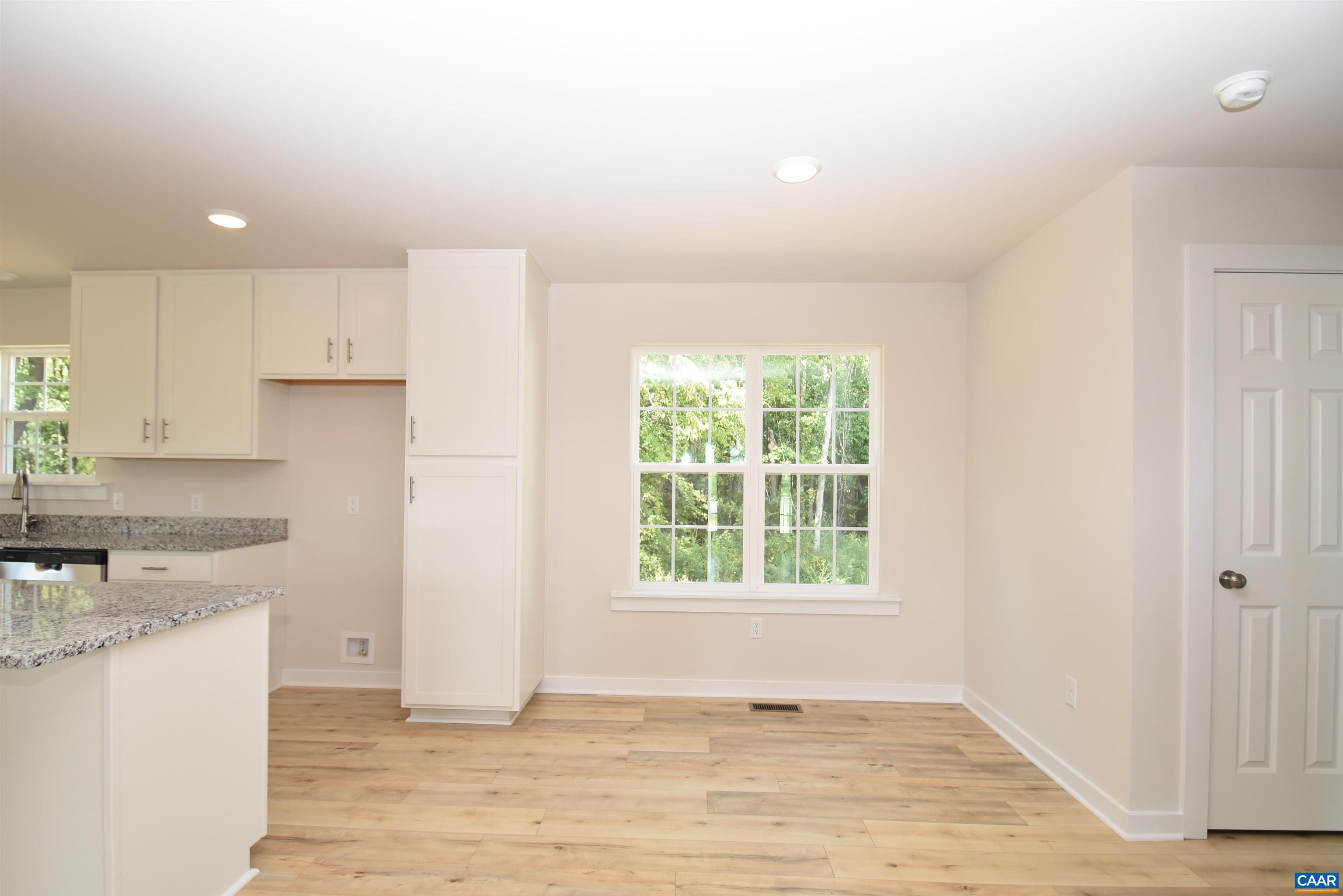 4635 James Madison Highway Fork Union, VA 23055 - Photo 11 of 22 an empty room with wooden floor and windows