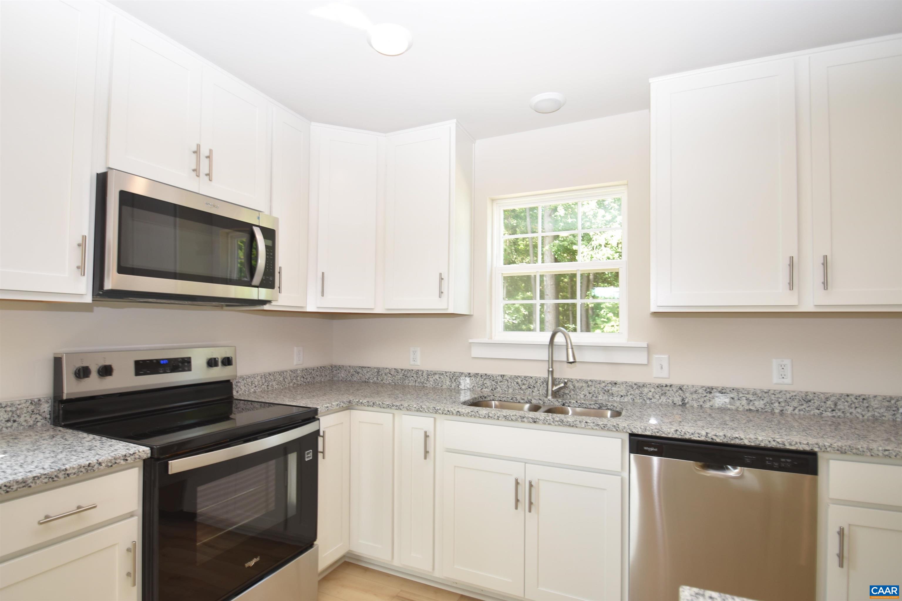 4635 James Madison Highway Fork Union, VA 23055 - Photo 8 of 22 a kitchen with stainless steel appliances granite countertop white cabinets granite counter tops and a window