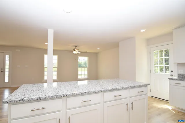 a bathroom with a granite countertop sink and a large mirror