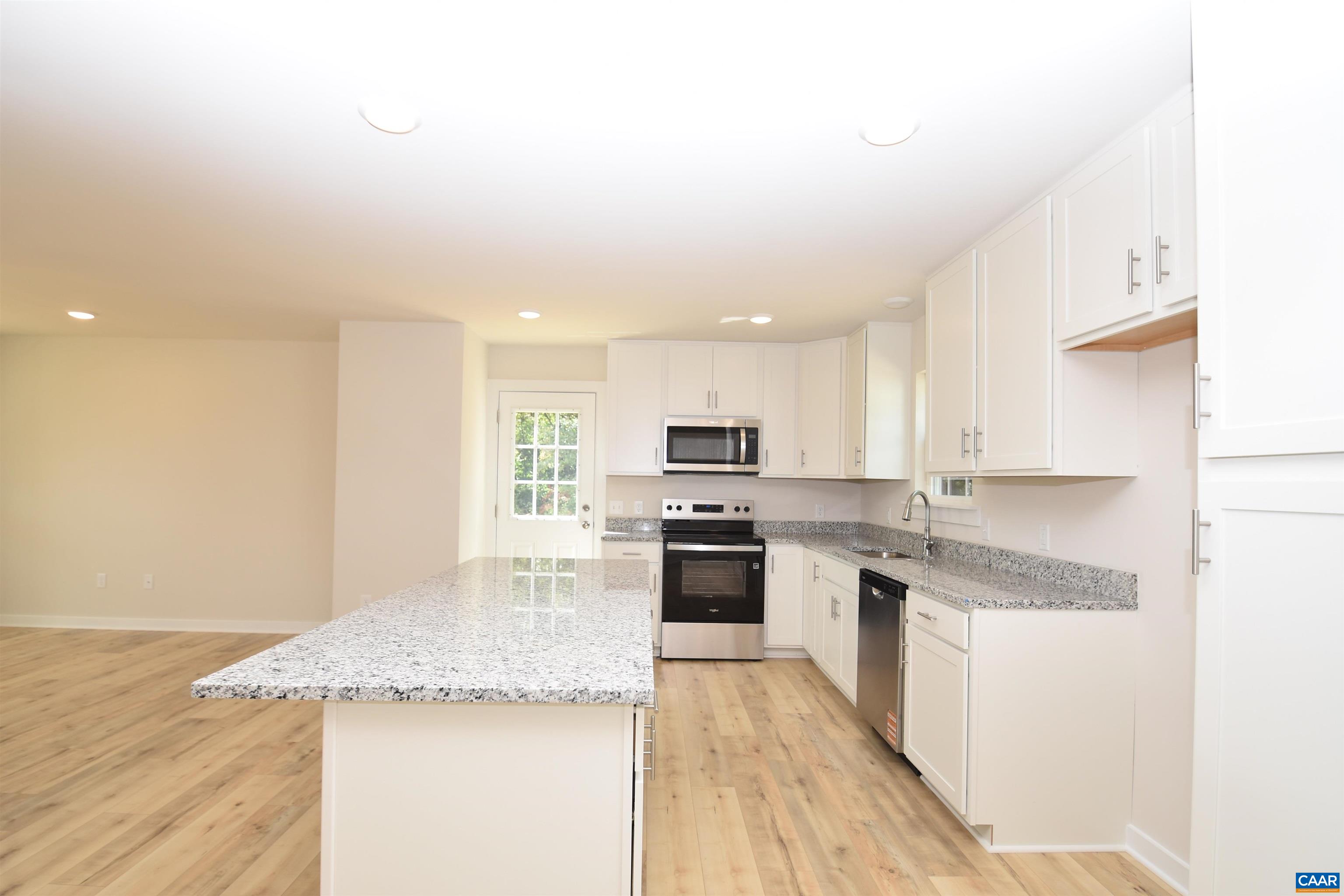 4635 James Madison Highway Fork Union, VA 23055 - Photo 10 of 22 a large kitchen with granite countertop a large counter top stainless steel appliances and cabinets