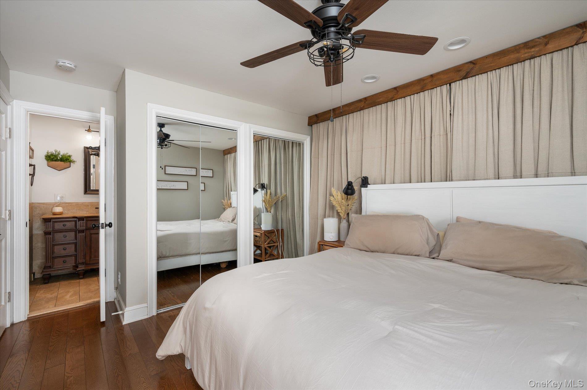 126 Walnut Road Kings Park, NY 11754 - Photo 13 of 33 a bedroom with a large bed and a chandelier