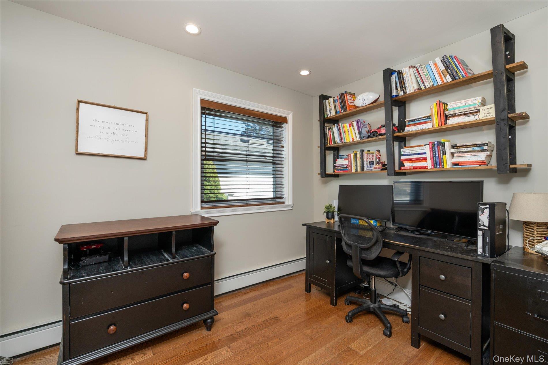 126 Walnut Road Kings Park, NY 11754 - Photo 16 of 33 a view of a workspace with furniture and a book shelf