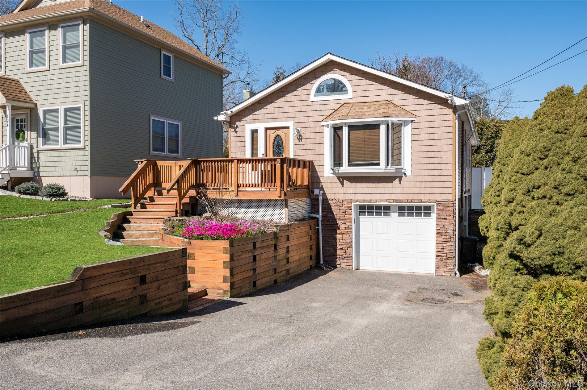 126 Walnut Road Kings Park, NY 11754 - Photo 2 of 33 a front view of a house with a garage