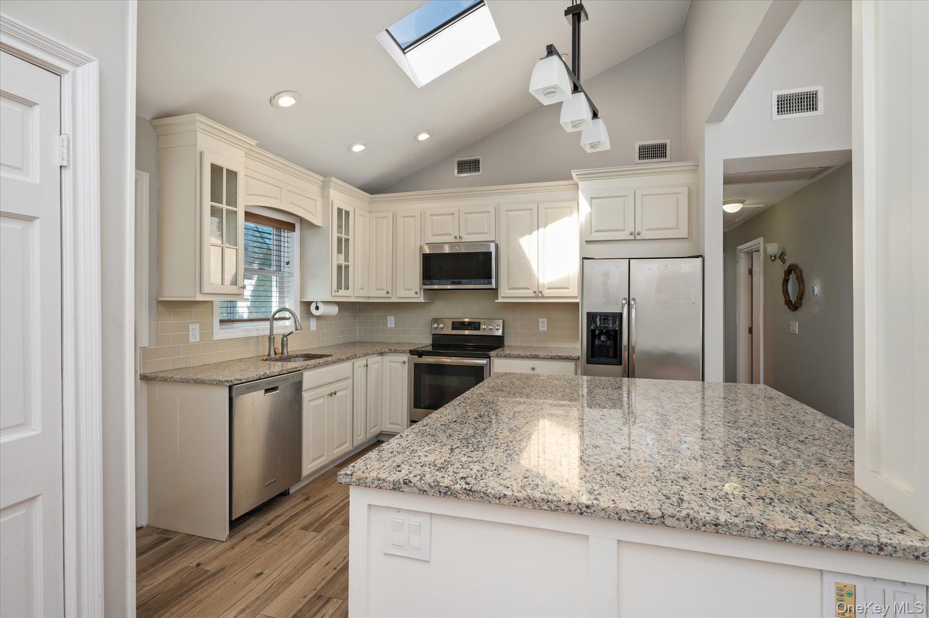 126 Walnut Road Kings Park, NY 11754 - Photo 8 of 33 a kitchen with stainless steel appliances granite countertop a sink a stove and a refrigerator