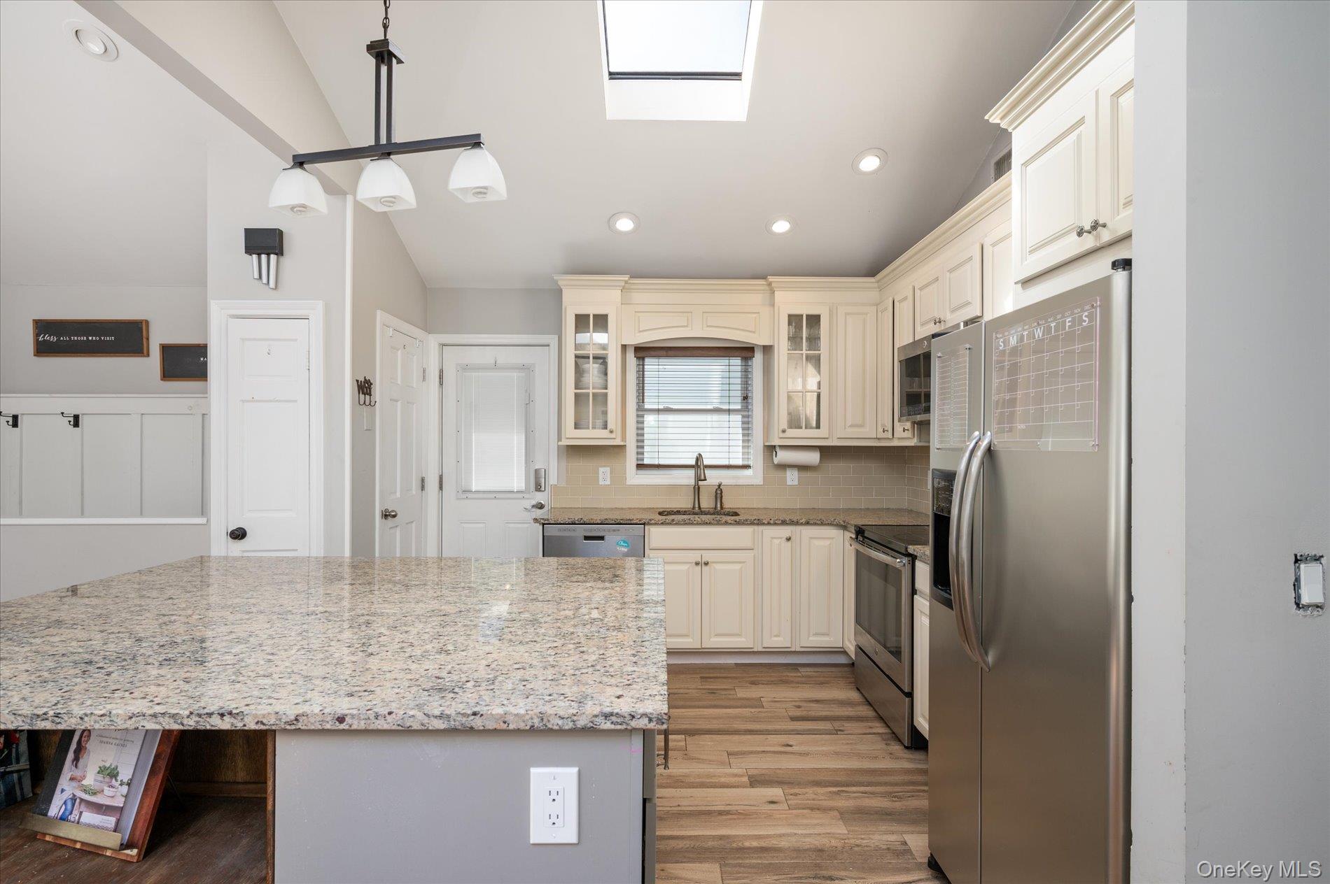 126 Walnut Road Kings Park, NY 11754 - Photo 9 of 33 a kitchen with stainless steel appliances granite countertop a sink refrigerator and cabinets