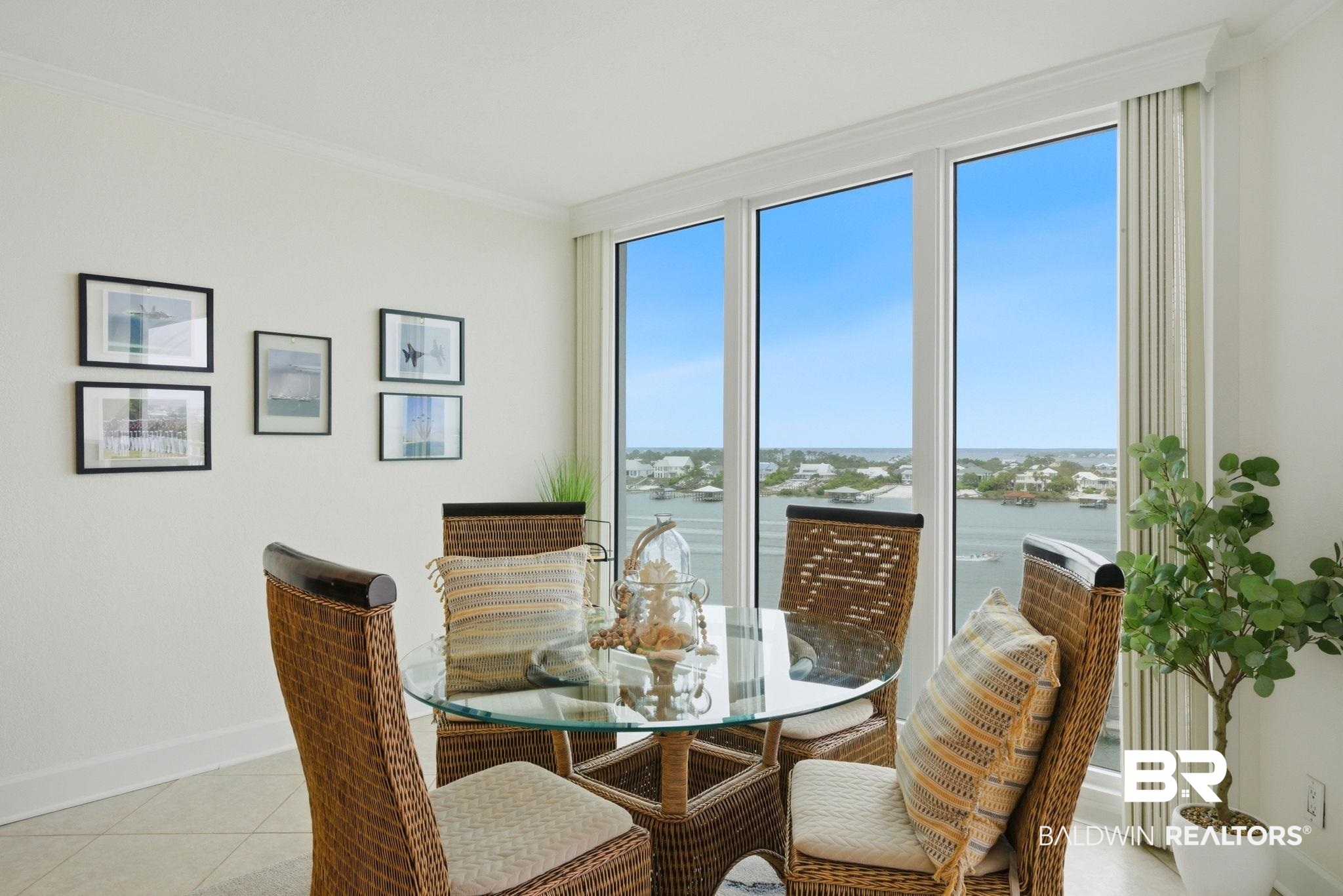 16284 Perdido Key Drive, Unit 912 Perdido Key, FL 32507 - Photo 18 of 49 Dining space with crown molding, a water view, and light tile patterned flooring