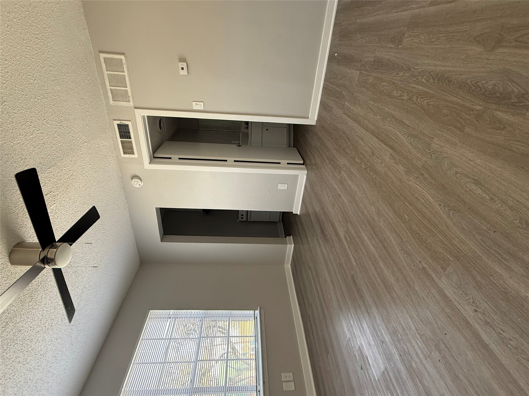311 East 31st Street, Unit 203B Austin, TX 78705 - Photo 2 of 8 an empty room with wooden floor and windows