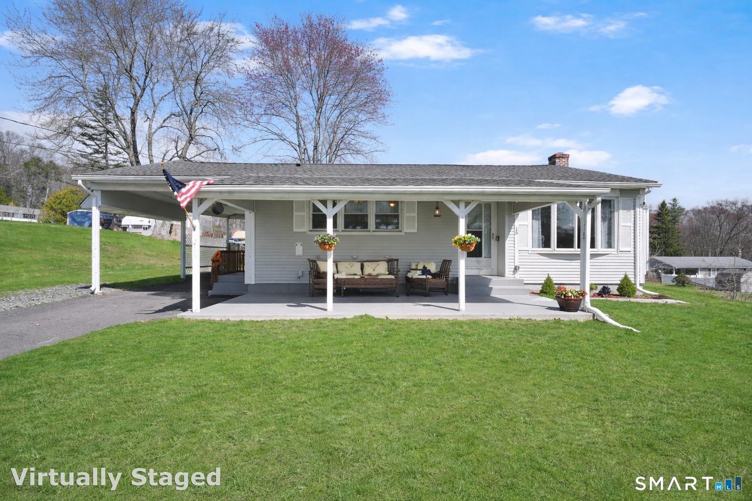 a view of a house with backyard porch and sitting area
