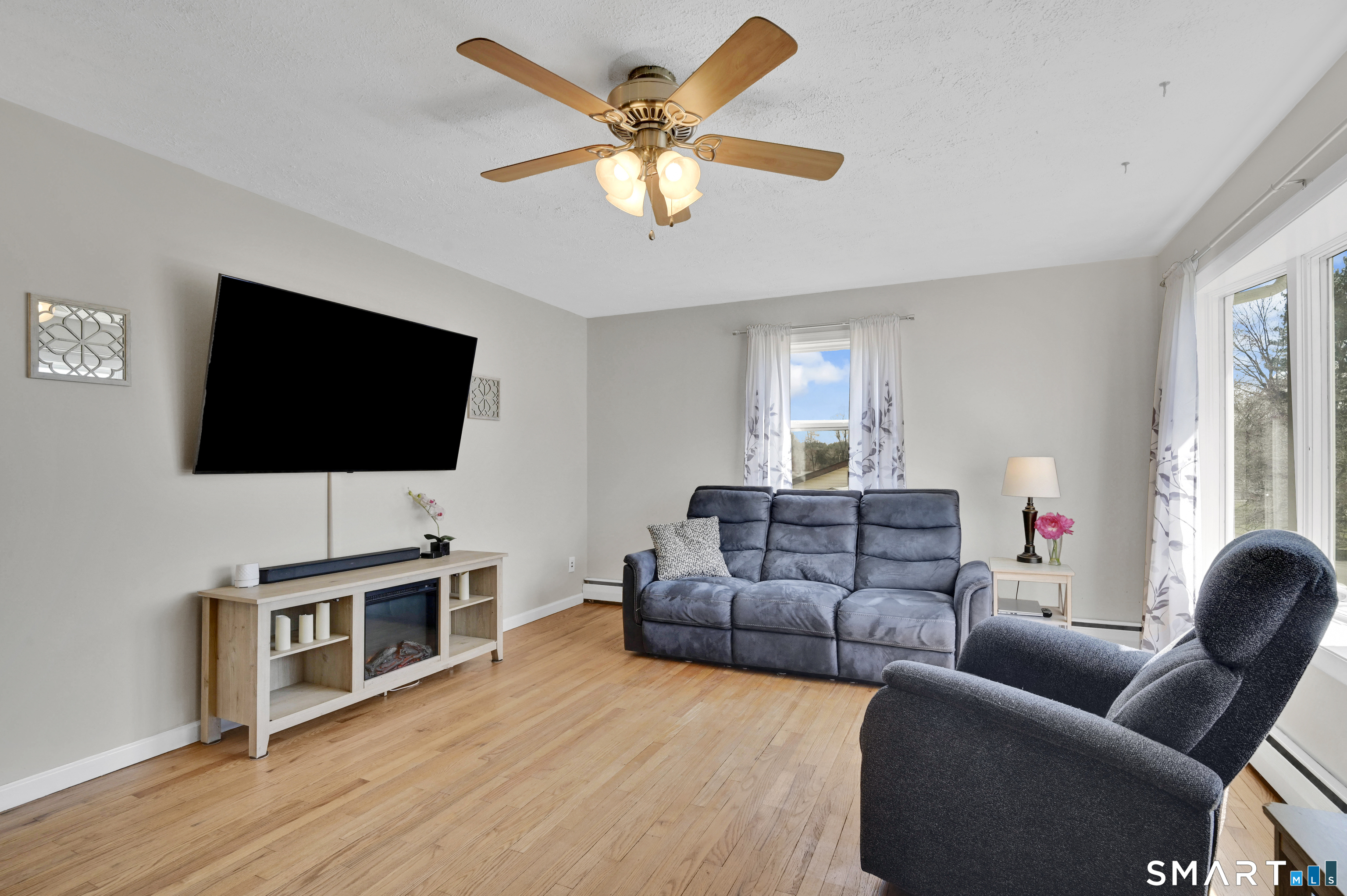 15 Meade Lane Enfield, CT 06082 - Photo 13 of 31 a living room with furniture and a flat screen tv