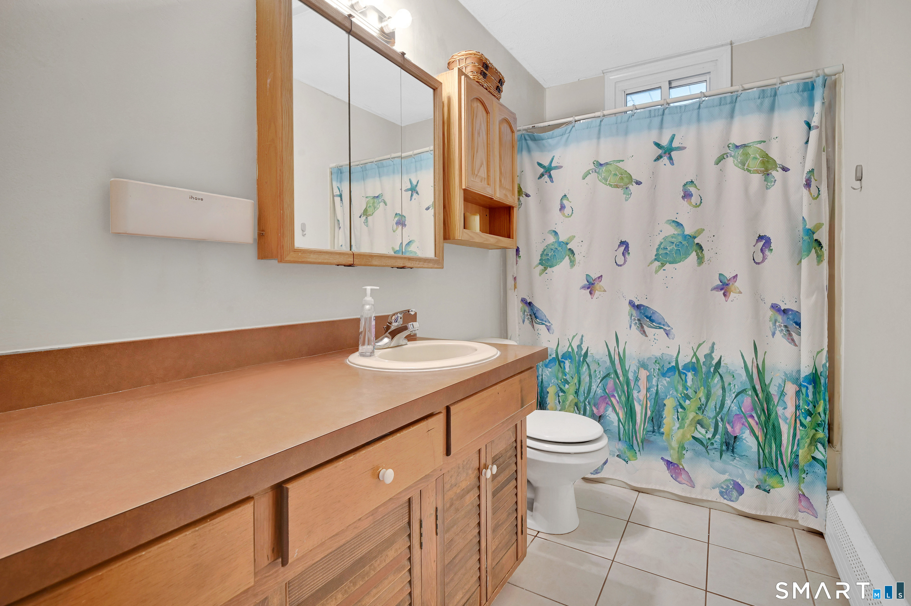 15 Meade Lane Enfield, CT 06082 - Photo 14 of 31 a bathroom with a sink a toilet and shower curtain