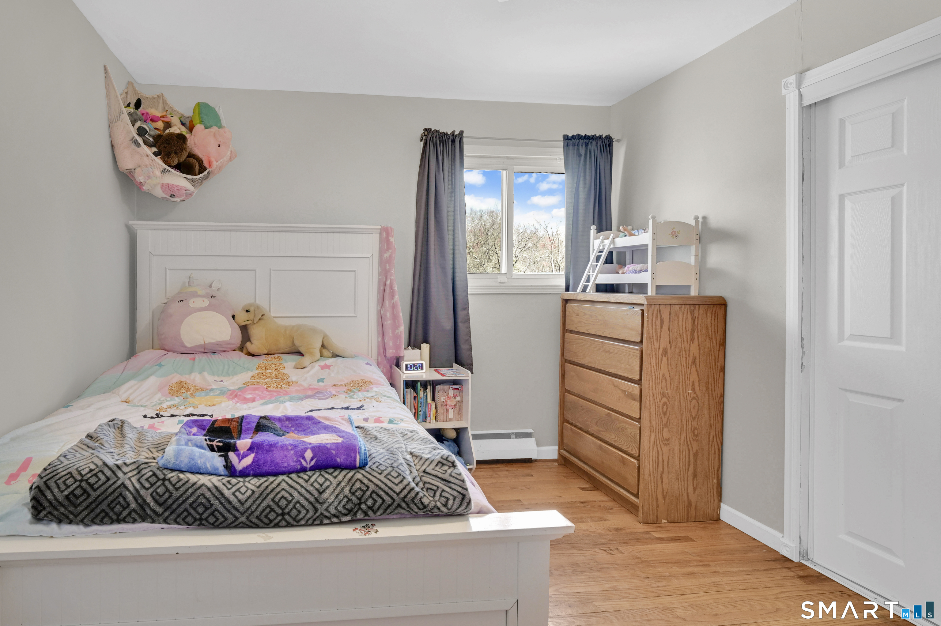15 Meade Lane Enfield, CT 06082 - Photo 19 of 31 a bedroom with a bed and wooden floor