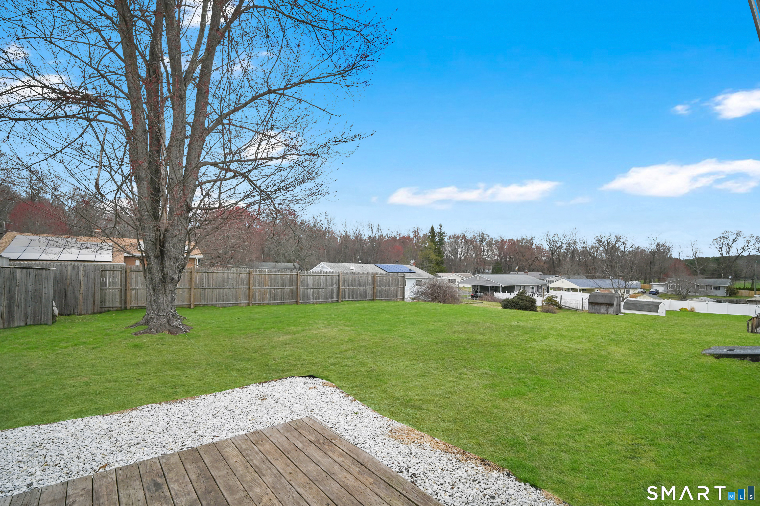 15 Meade Lane Enfield, CT 06082 - Photo 26 of 31 a backyard of a house with table and chairs