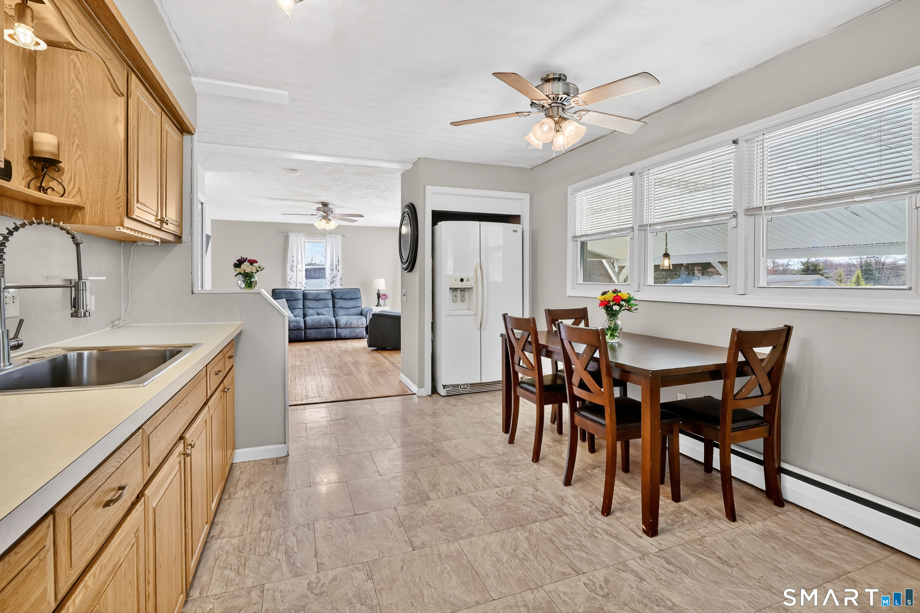 15 Meade Lane Enfield, CT 06082 - Photo 5 of 31 a kitchen with stainless steel appliances kitchen island granite countertop a table chairs and a refrigerator