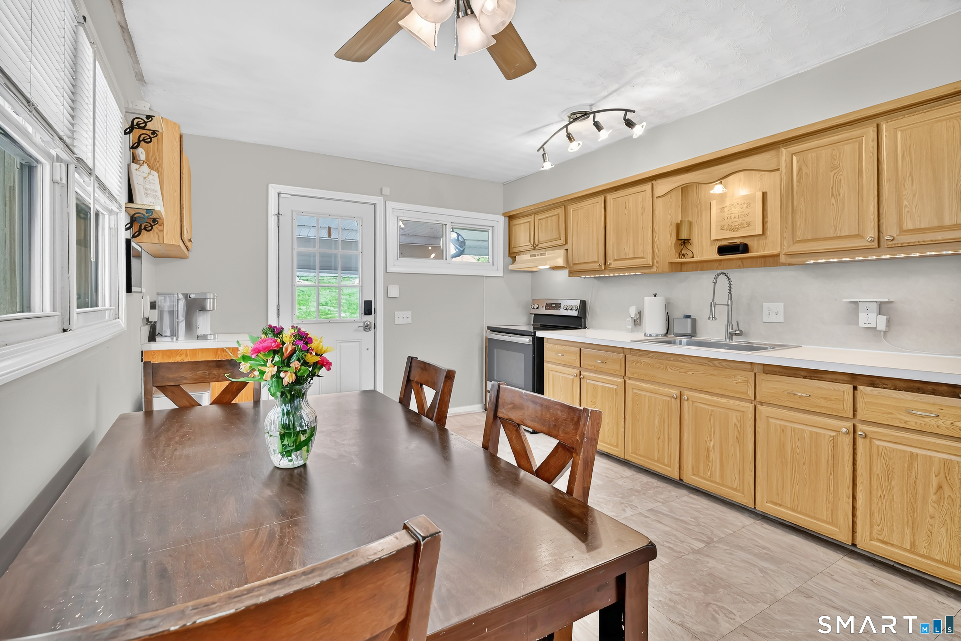 15 Meade Lane Enfield, CT 06082 - Photo 6 of 31 a kitchen with sink refrigerator dining table and chairs