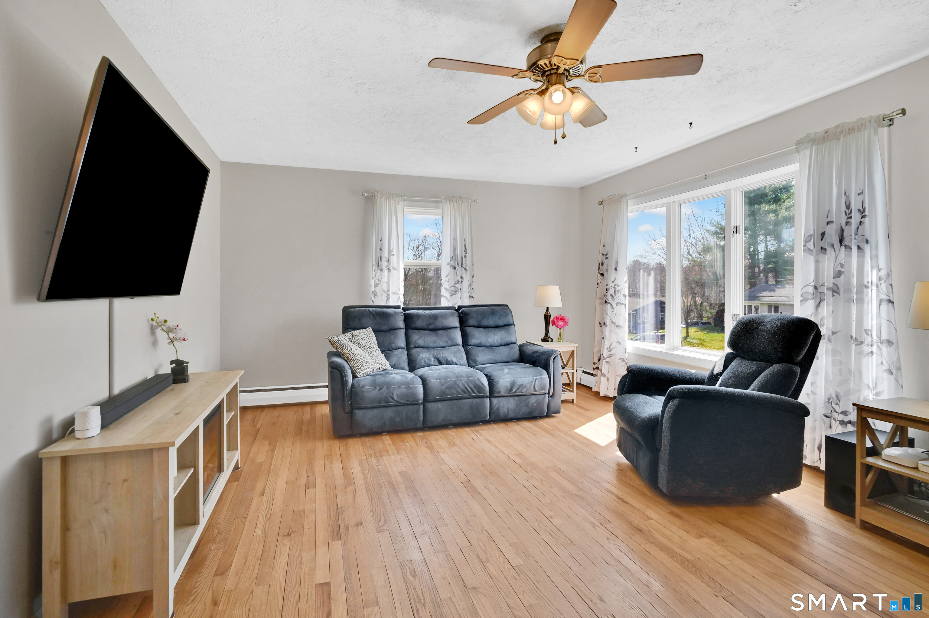 15 Meade Lane Enfield, CT 06082 - Photo 10 of 31 a living room with furniture and a flat screen tv
