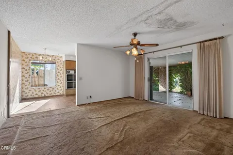 a view of an empty room with glass door
