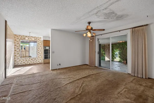 a view of an empty room with glass door
