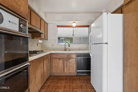 a kitchen with stainless steel appliances a refrigerator and a sink
