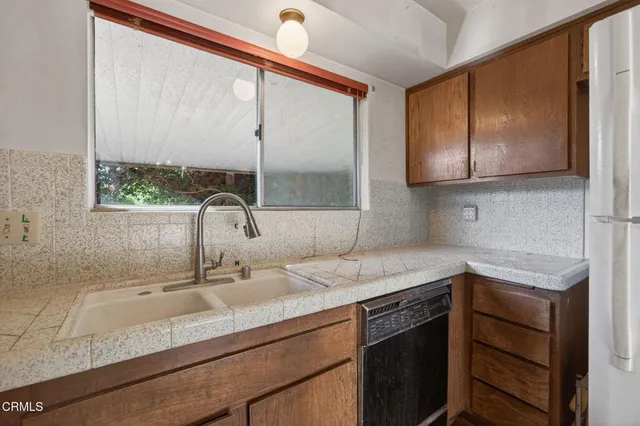 a kitchen with a sink and a window