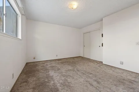 an empty room with a painting on the wall