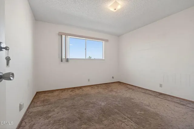 a wooden bench sitting in backside of a house
