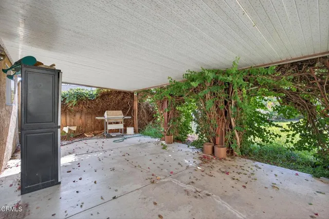 a backyard of a house with a stove and refrigerator
