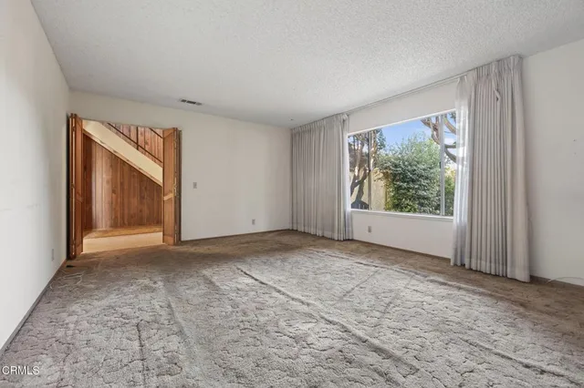 a view of an empty room with a window