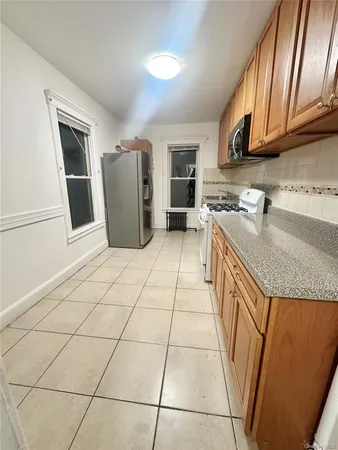 a kitchen with stainless steel appliances granite countertop a sink stove and cabinets