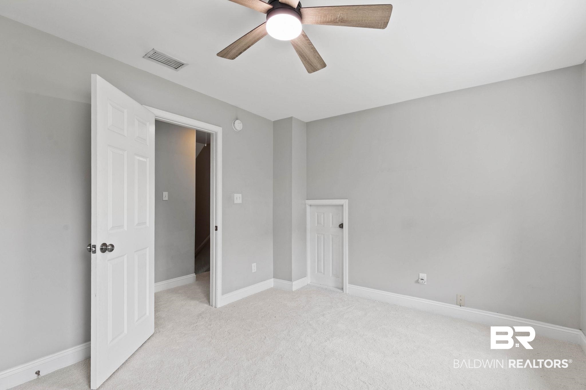 22810 High Ridge Road Fairhope, AL 36532 - Photo 46 of 78 Carpeted room featuring a ceiling fan with integrated lighting, a paneled door, and a smaller access door