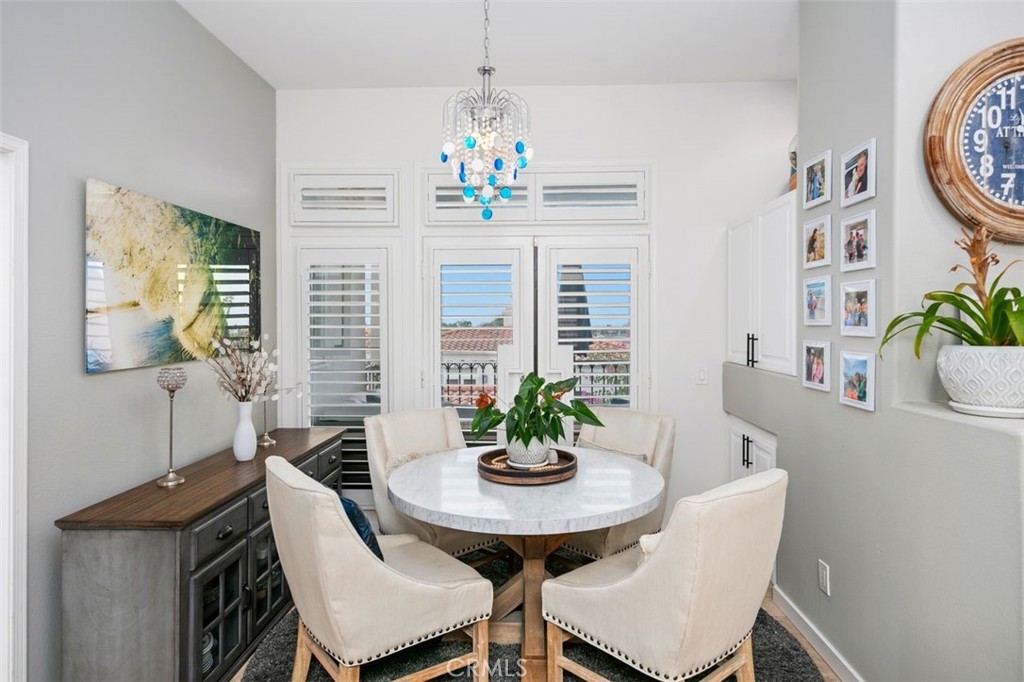 876 Cofair Court Solana Beach, CA 92075 - Photo 15 of 32 a dining room with furniture potted plants and wooden floor