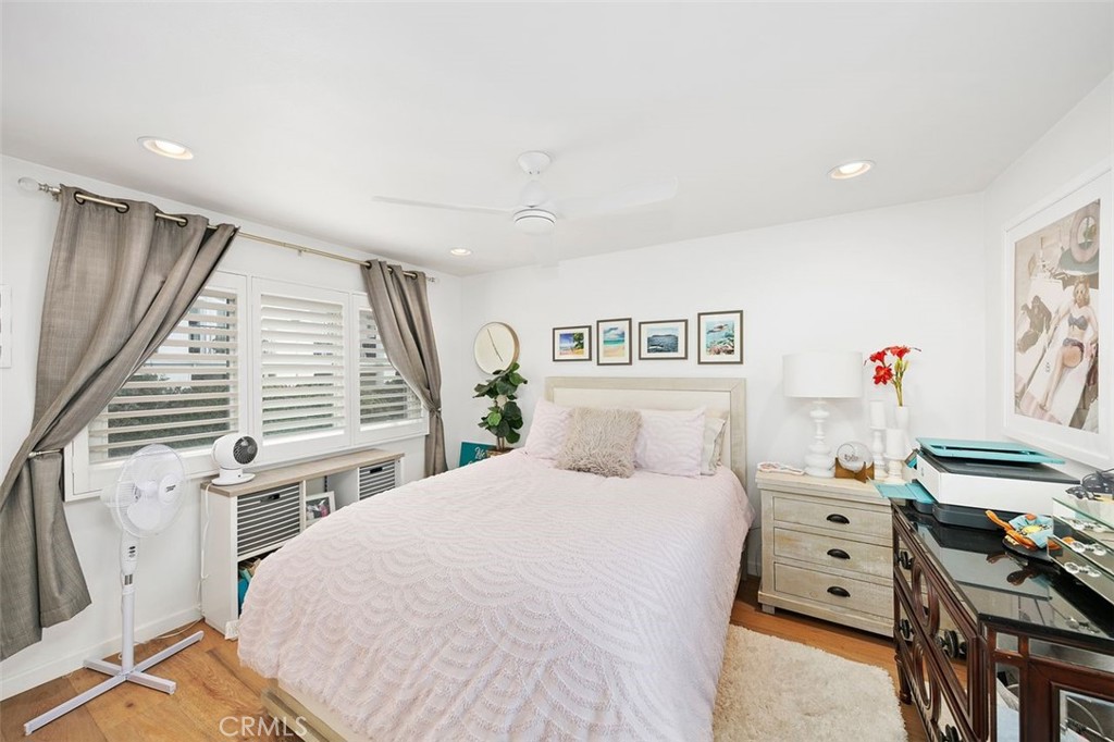 876 Cofair Court Solana Beach, CA 92075 - Photo 26 of 32 a bedroom with a bed and a flat tv screen on the dresser