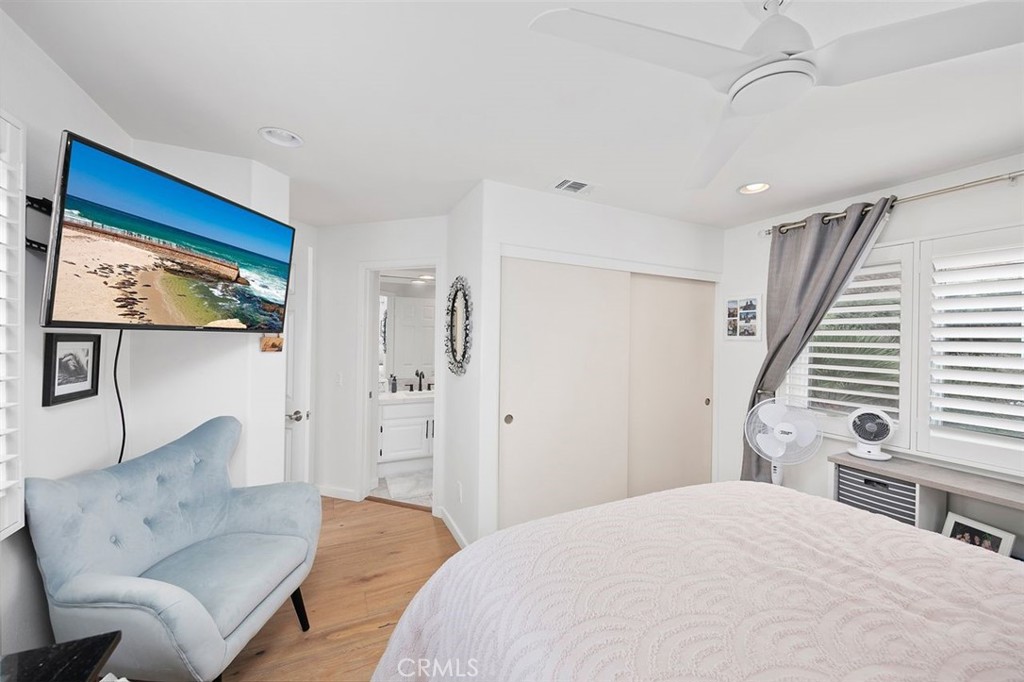 876 Cofair Court Solana Beach, CA 92075 - Photo 27 of 32 a spacious bedroom with a bed and a couch