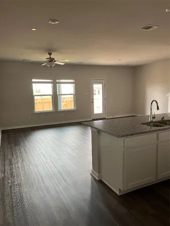 a living room with hard wood floors and a window