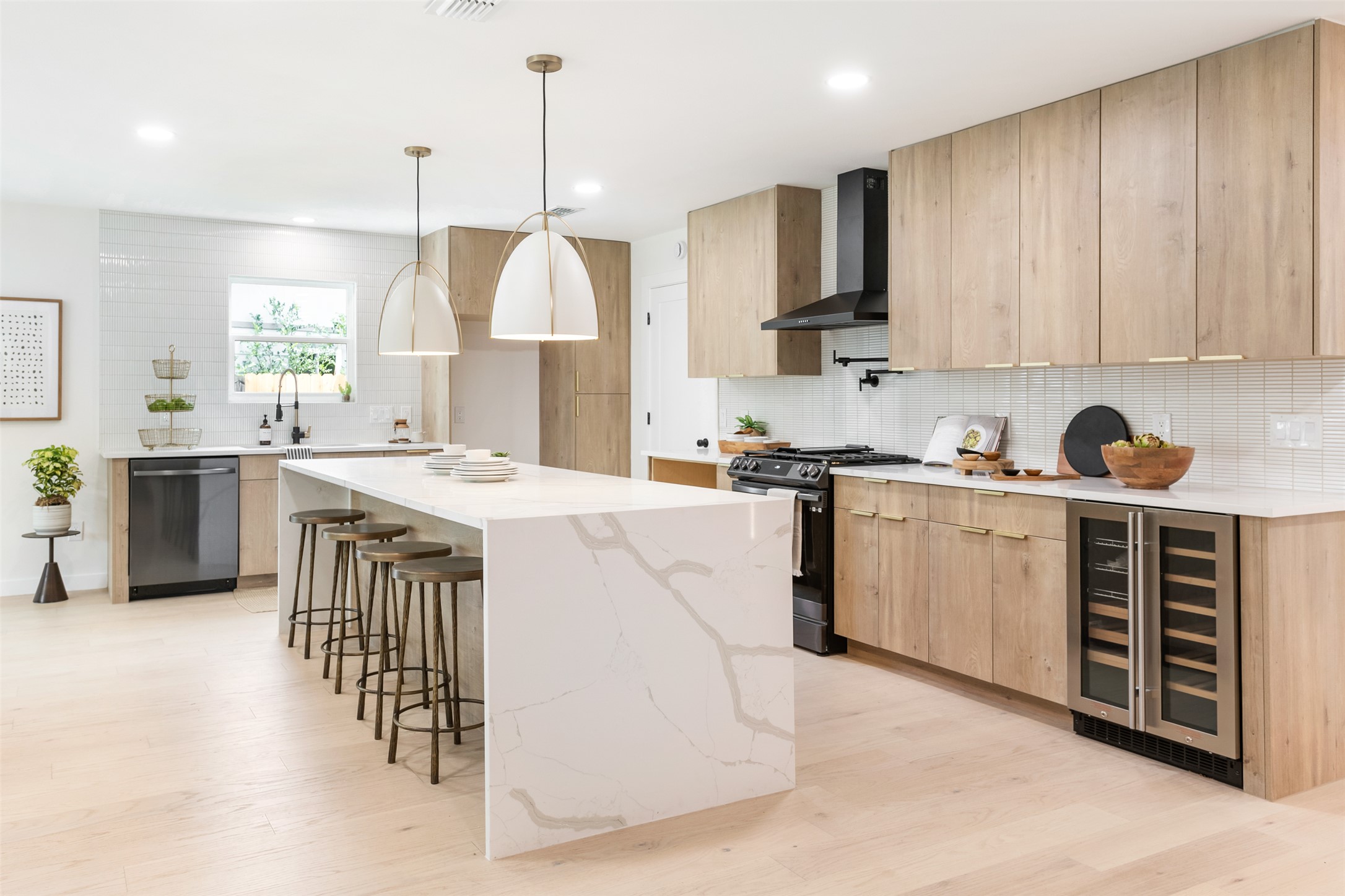 7604 Islander Drive Austin, TX 78749 - Photo 1 of 38 Culinary aspirations meet contemporary design in this open-concept kitchen with light wood cabinetry.